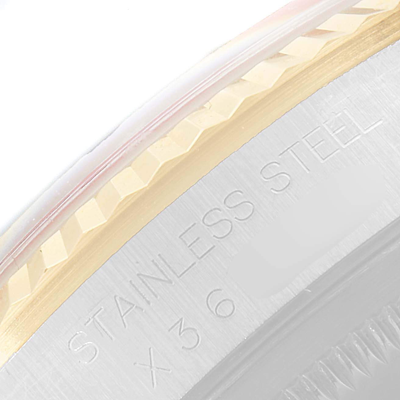 The image shows a close-up of the bezel and engraved case side of a Rolex Datejust 16233 Men
s Steel and Gold (two tone) Black Dial 16233 Men
s Steel and Gold (two tone) Black Dial watch, indicating "STAINLESS STEEL."