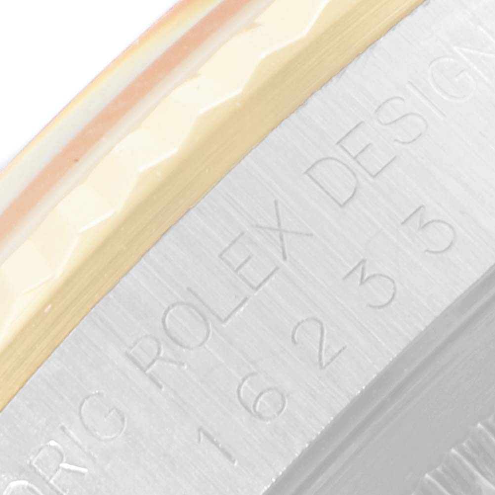 The image shows a close-up of the engraving on the side of the Rolex Datejust 16233 Men
s Steel and Gold (two tone) Black Dial 16233 Men
s Steel and Gold (two tone) Black Dial watch case.