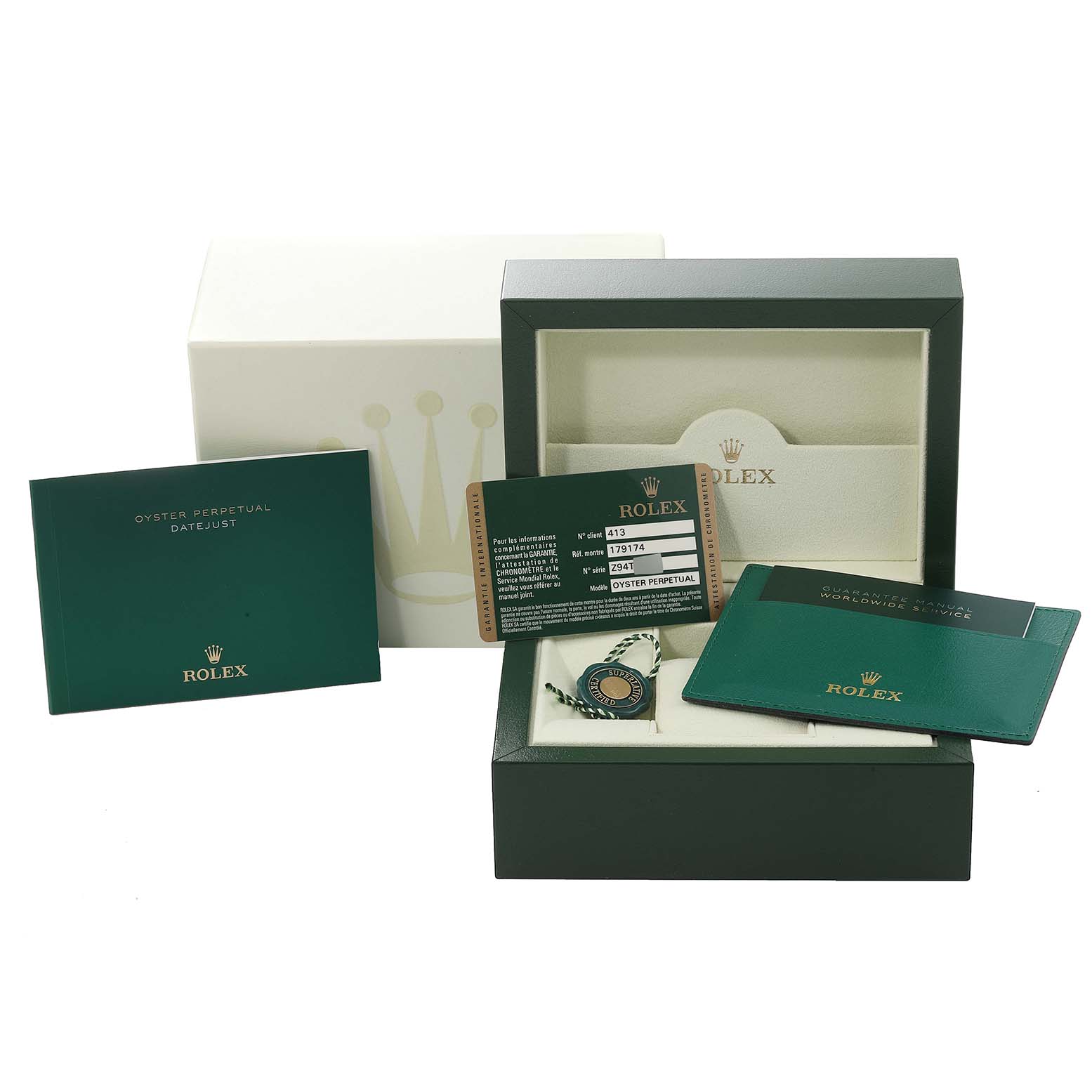 The image shows the packaging and accessories of a Rolex Datejust 179174 Women's Stainless Steel Mother of Pearl Dial 179174 Women's Stainless Steel Mother of Pearl Dial watch, including the box, manuals, tags, and warranty card.
