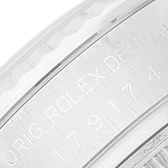 This image shows a close-up of the engraved edge of the bezel or case back of a Rolex Datejust 179174 Women's Stainless Steel Mother of Pearl Dial 179174 Women's Stainless Steel Mother of Pearl Dial model watch.