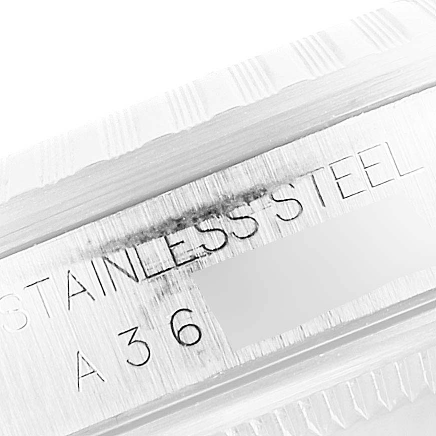 This image shows a close-up view of the stainless steel bezel and part of the case of a Rolex Datejust 16234 Men
s Stainless Steel White Dial 16234 Men
s Stainless Steel White Dial watch.