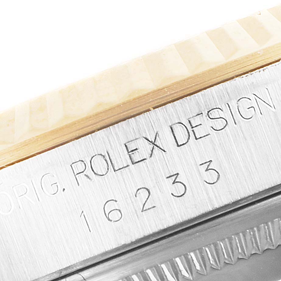 This close-up image shows the model number and part of the bezel of a Rolex Datejust 16233 Men
s Steel and Gold (two tone) Mother of Pearl Dial 16233 Men
s Steel and Gold (two tone) Mother of Pearl Dial watch.