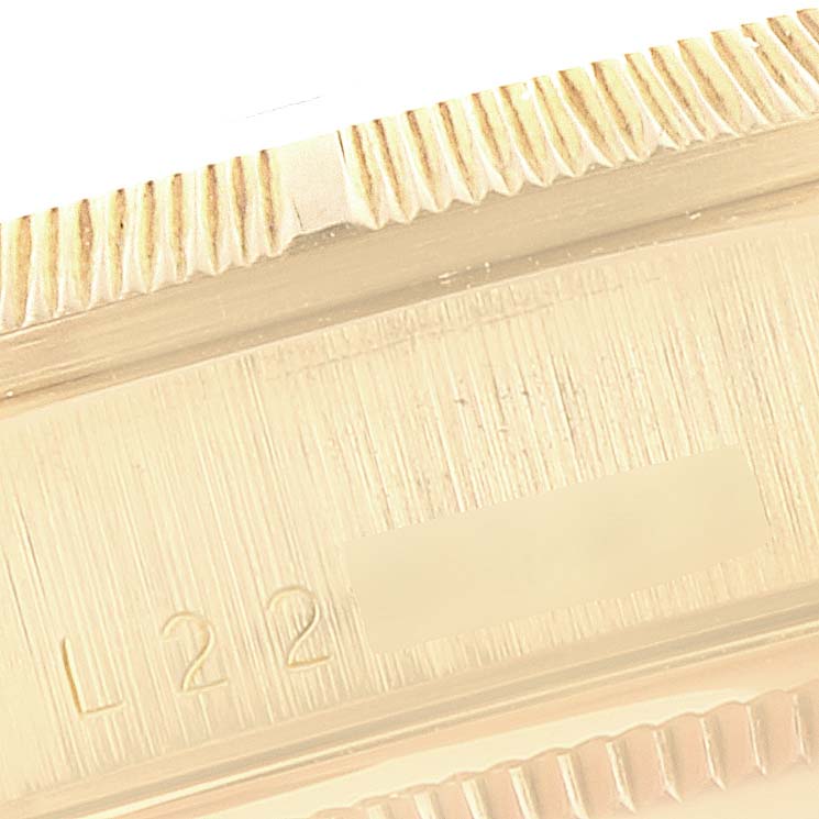 The image shows a close-up view of the bezel and part of the case of the Rolex President 1989-1990 Men
s Yellow Gold Champagne Dial 1989-1990 Men
s Yellow Gold Champagne Dial model watch.