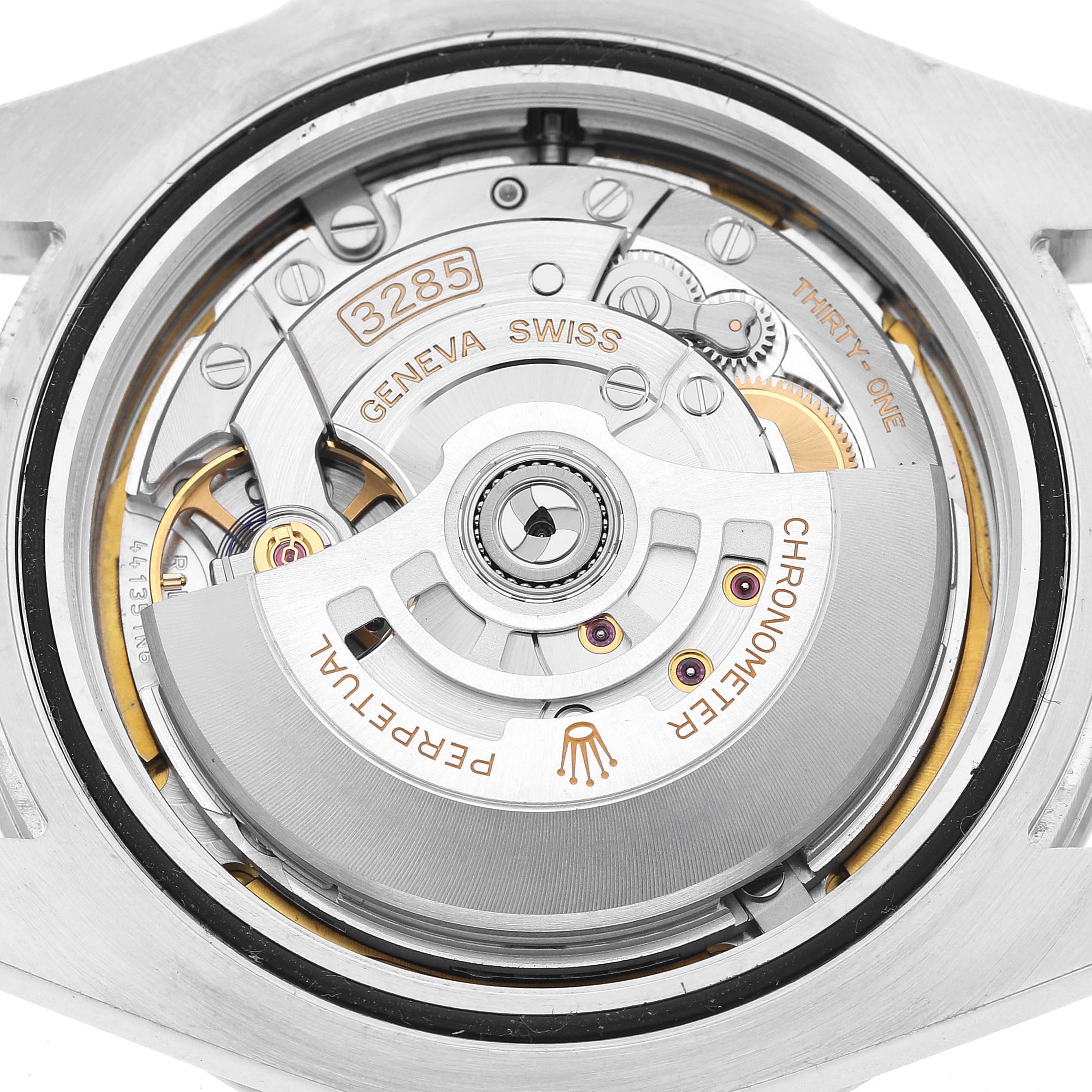 The image shows the movement of a Rolex Explorer 226570 Men's Stainless Steel Black Dial watch, highlighting the rotor and intricate internal components from a top-down angle.