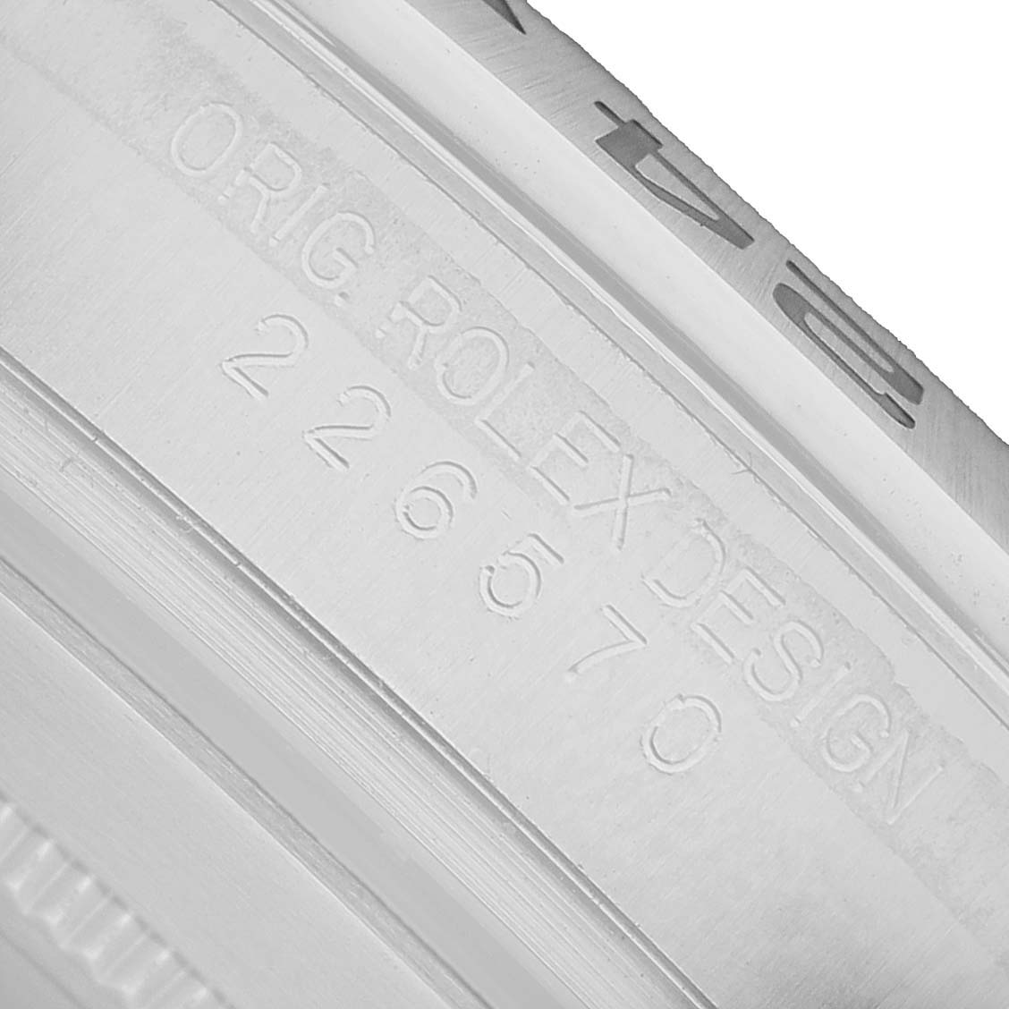 The image shows a close-up of the case engraving on a Rolex Explorer 226570 Men's Stainless Steel Black Dial, revealing the model number and branding.