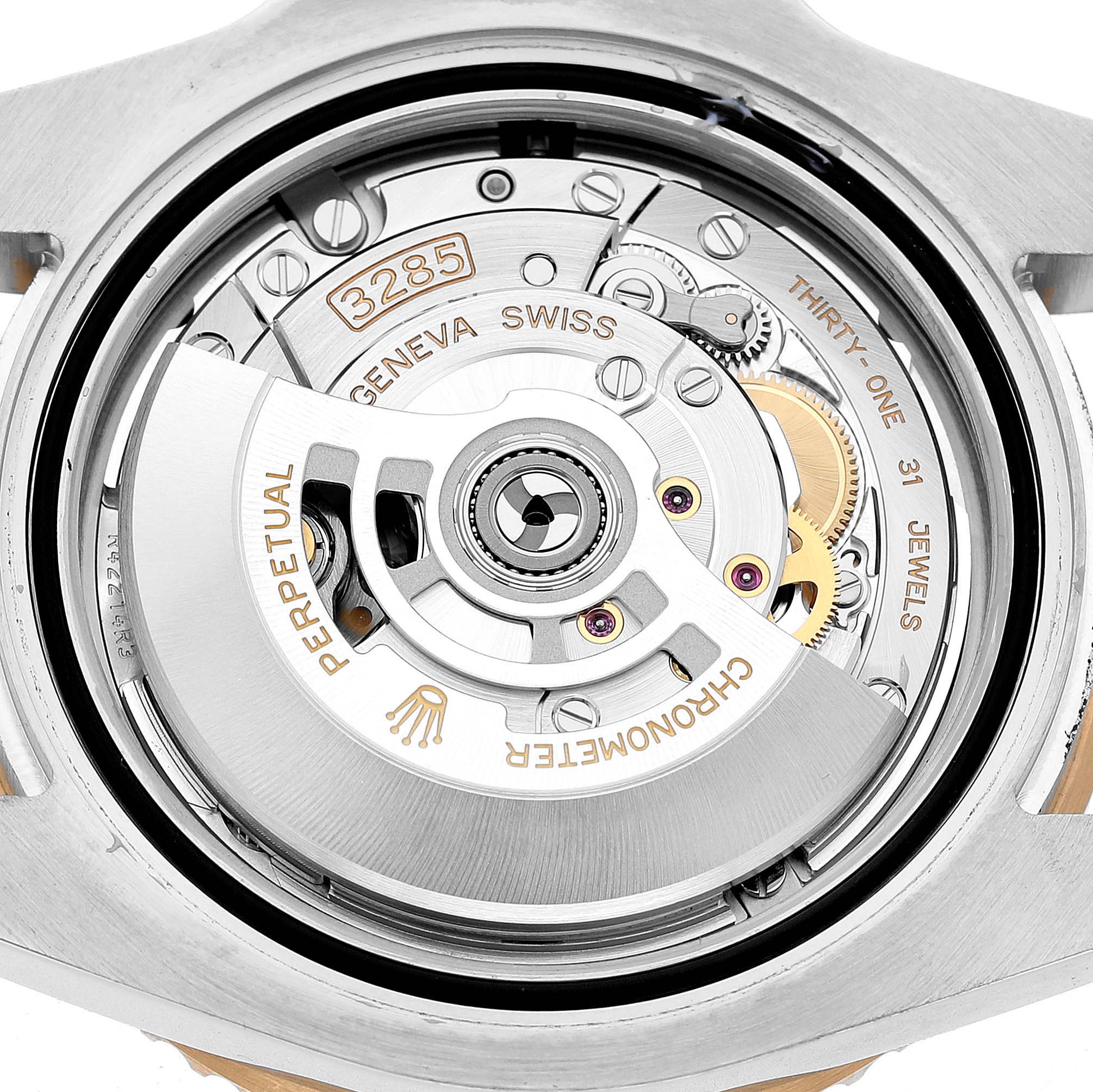 The image shows the movement of a Rolex GMT-Master 126713 Men's Steel and Gold (two tone) Black Dial watch, focusing on its internal mechanics and rotor.