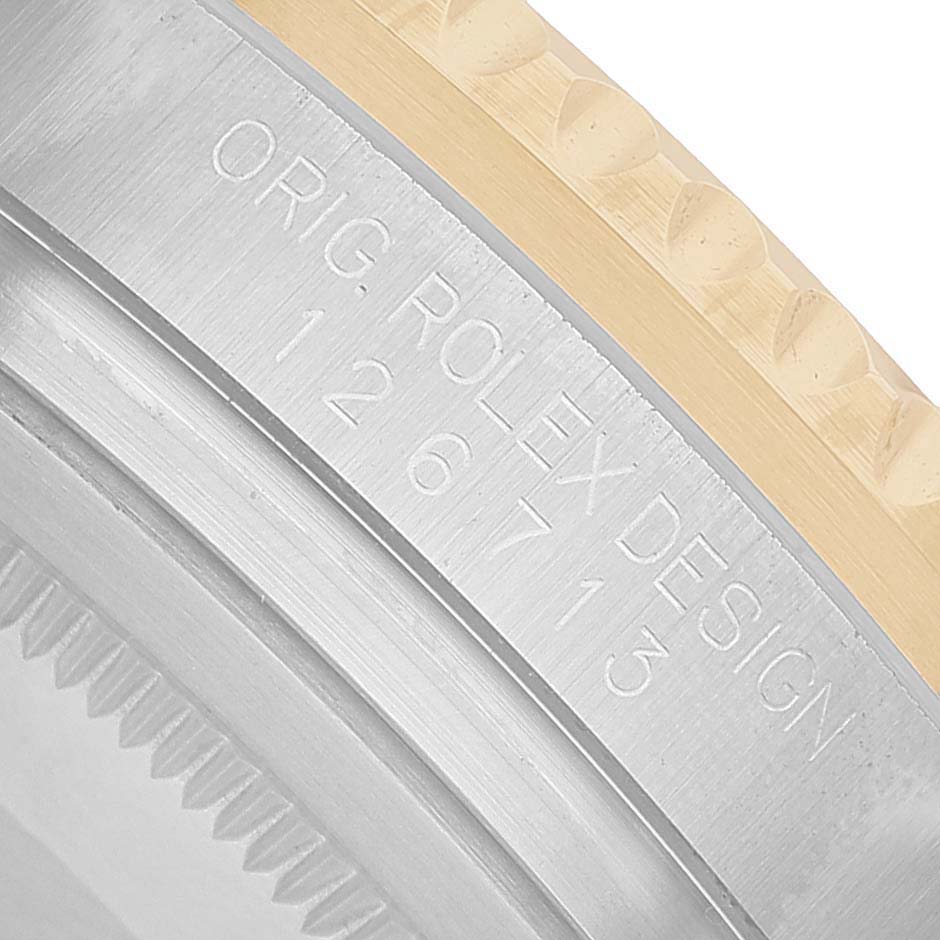 The image shows a close-up of the side and case back of a Rolex GMT-Master 126713 Men's Steel and Gold (two tone) Black Dial, highlighting the model engraving.