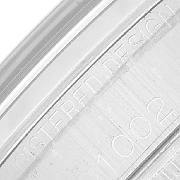 This image shows a close-up of the engraved text on the casing of a Rolex Oyster Perpetual 1002 Men's Stainless Steel Grey Dial 1002 Men's Stainless Steel Grey Dial watch.