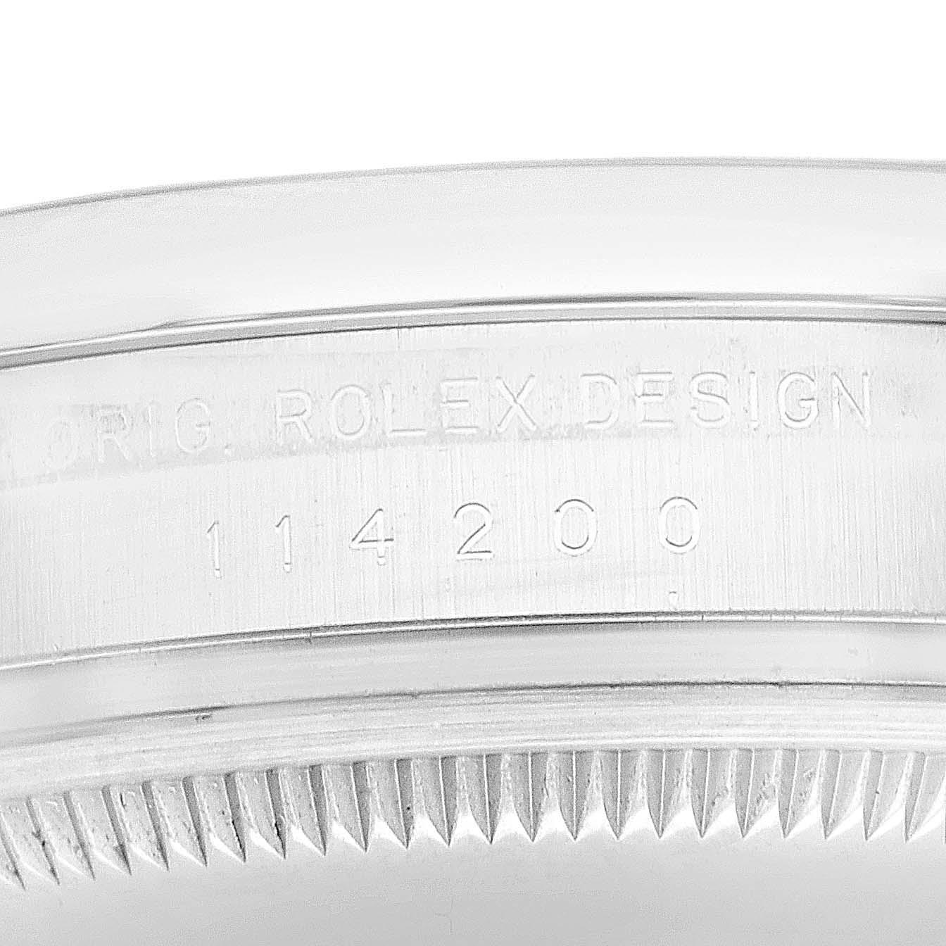 This image shows the side view of the bezel and case part of a Rolex Oyster Perpetual 114200 Men
s Stainless Steel Green Dial 114200 Men
s Stainless Steel Green Dial watch, with the model number 114200 engraved.