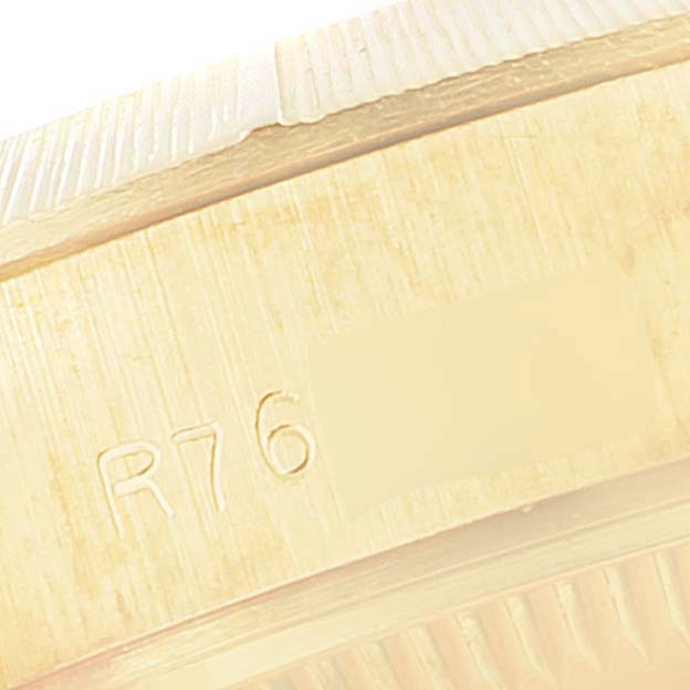 The image shows a close-up of the side of the Rolex President 69278 Women
s Yellow Gold Champagne Dial 69278 Women
s Yellow Gold Champagne Dial model watch, focusing on the serial number engraving.