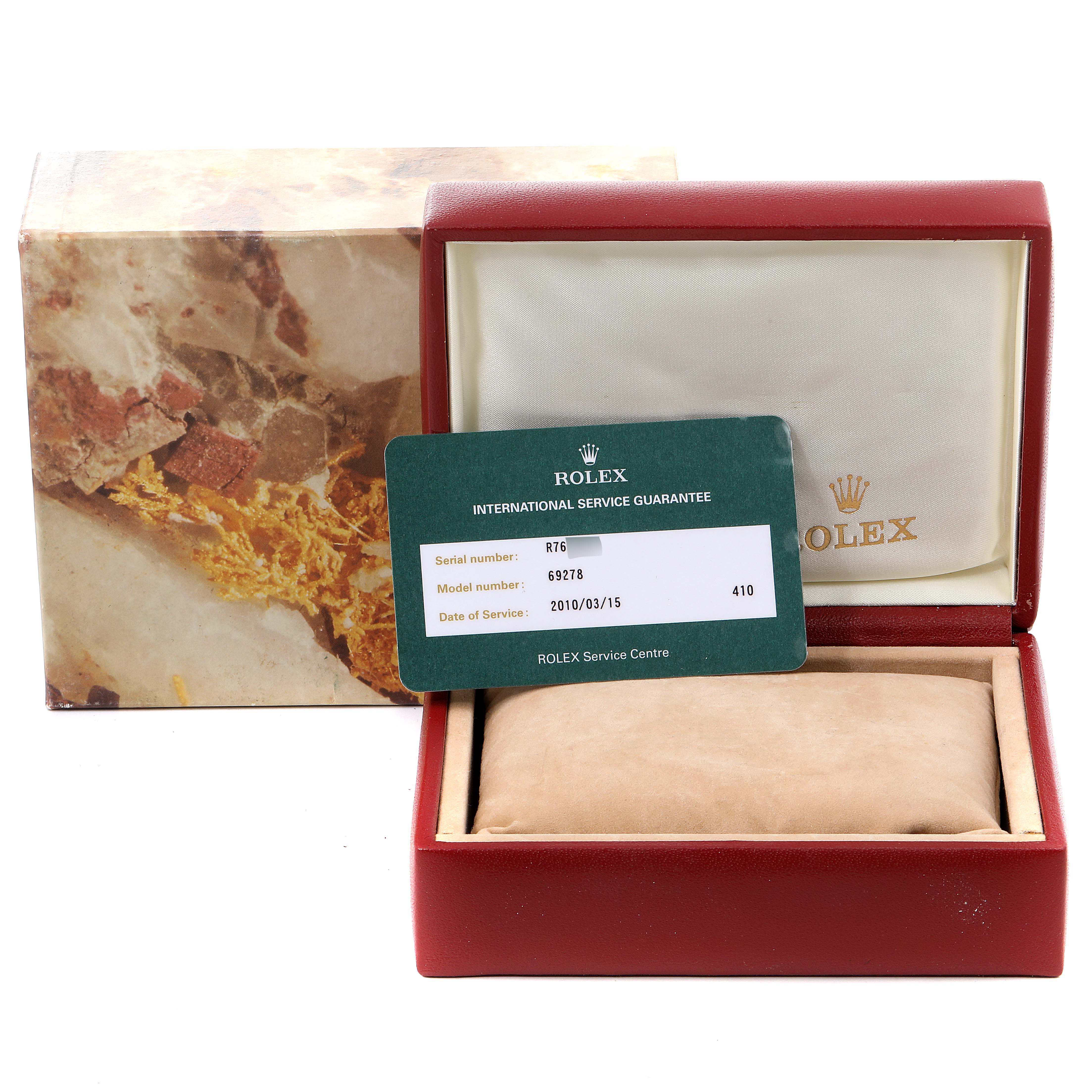 This image shows a Rolex President 69278 Women
s Yellow Gold Champagne Dial 69278 Women
s Yellow Gold Champagne Dial model box, service guarantee card, and pillow, angled from the front.