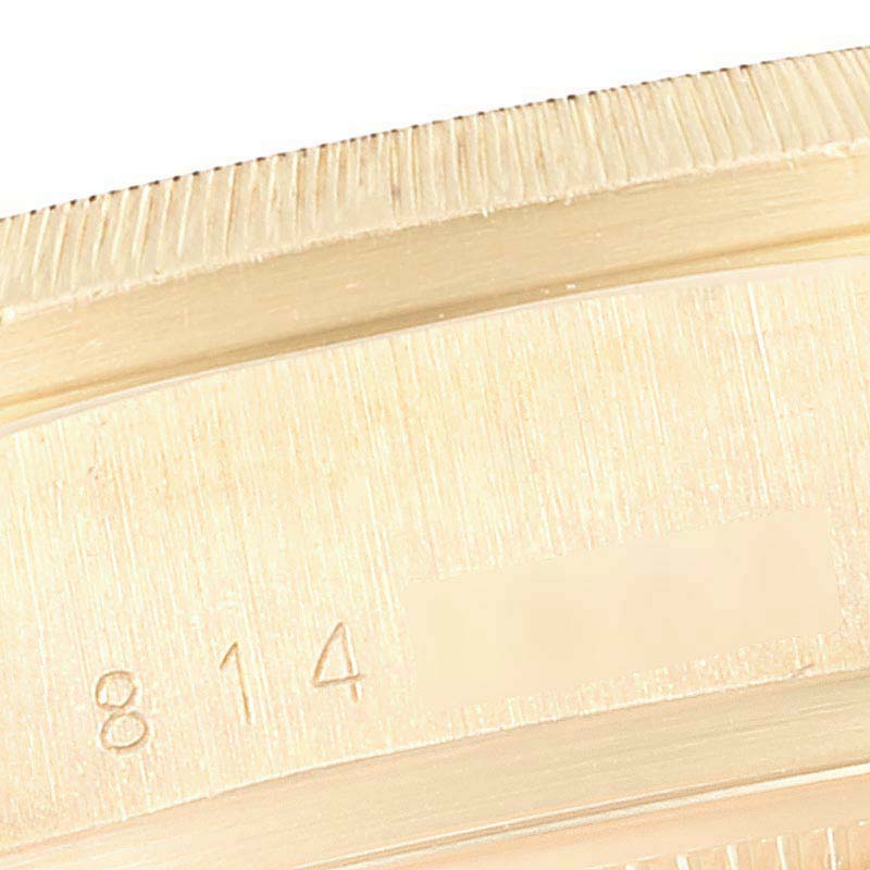 This image shows a close-up of the case back and edge of a Rolex President 18078 Men
s Yellow Gold Black Dial 18078 Men
s Yellow Gold Black Dial model watch, highlighting its engraved serial number.