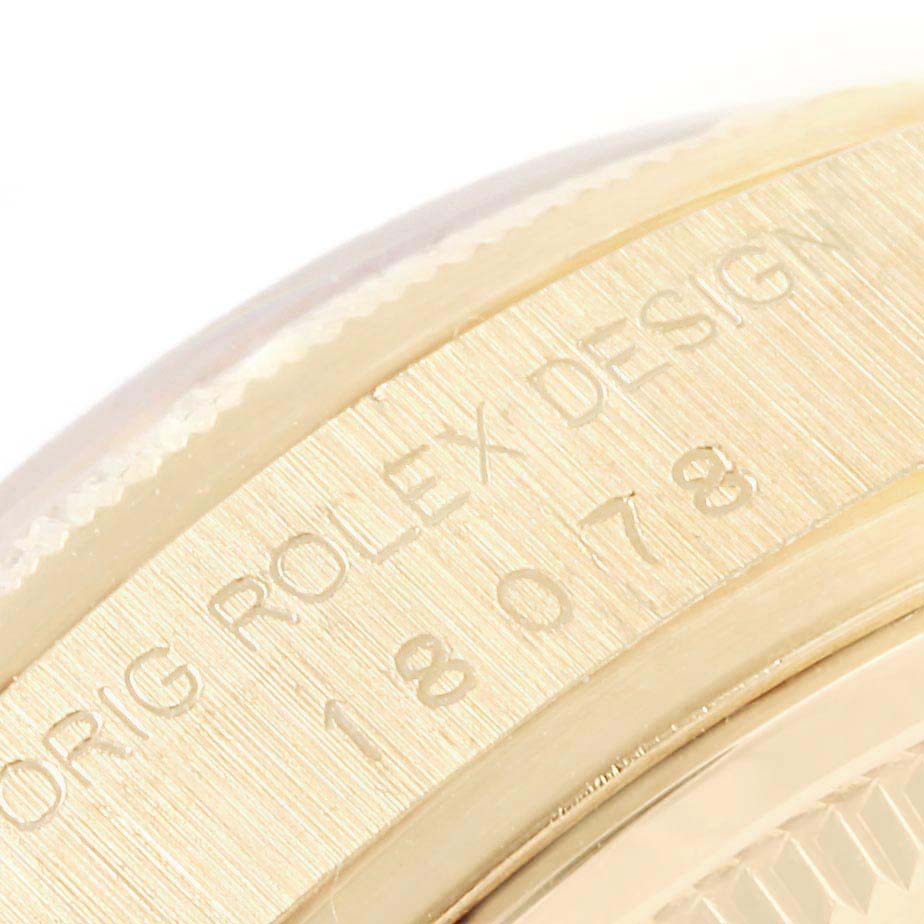 This close-up image shows the engraved model number and part of the case of a Rolex President 18078 Men
s Yellow Gold Black Dial 18078 Men
s Yellow Gold Black Dial watch.