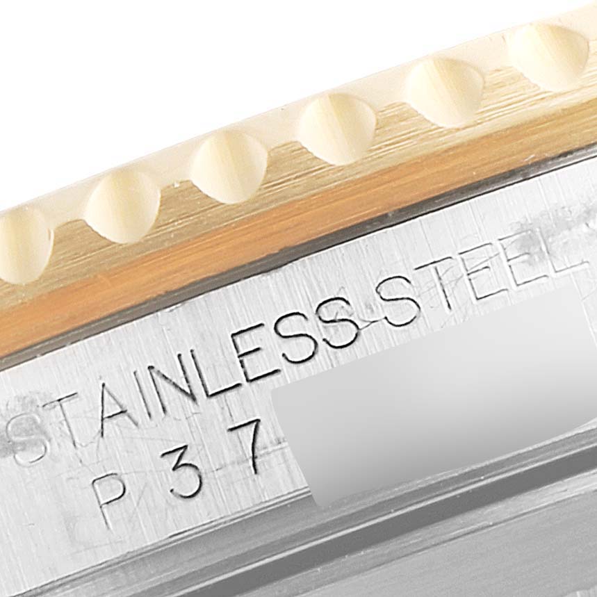 This image shows a close-up of the engraved case and notched bezel of a Rolex Submariner 16613 Men's Steel and Gold (two tone) Black Dial 16613 Men's Steel and Gold (two tone) Black Dial watch.