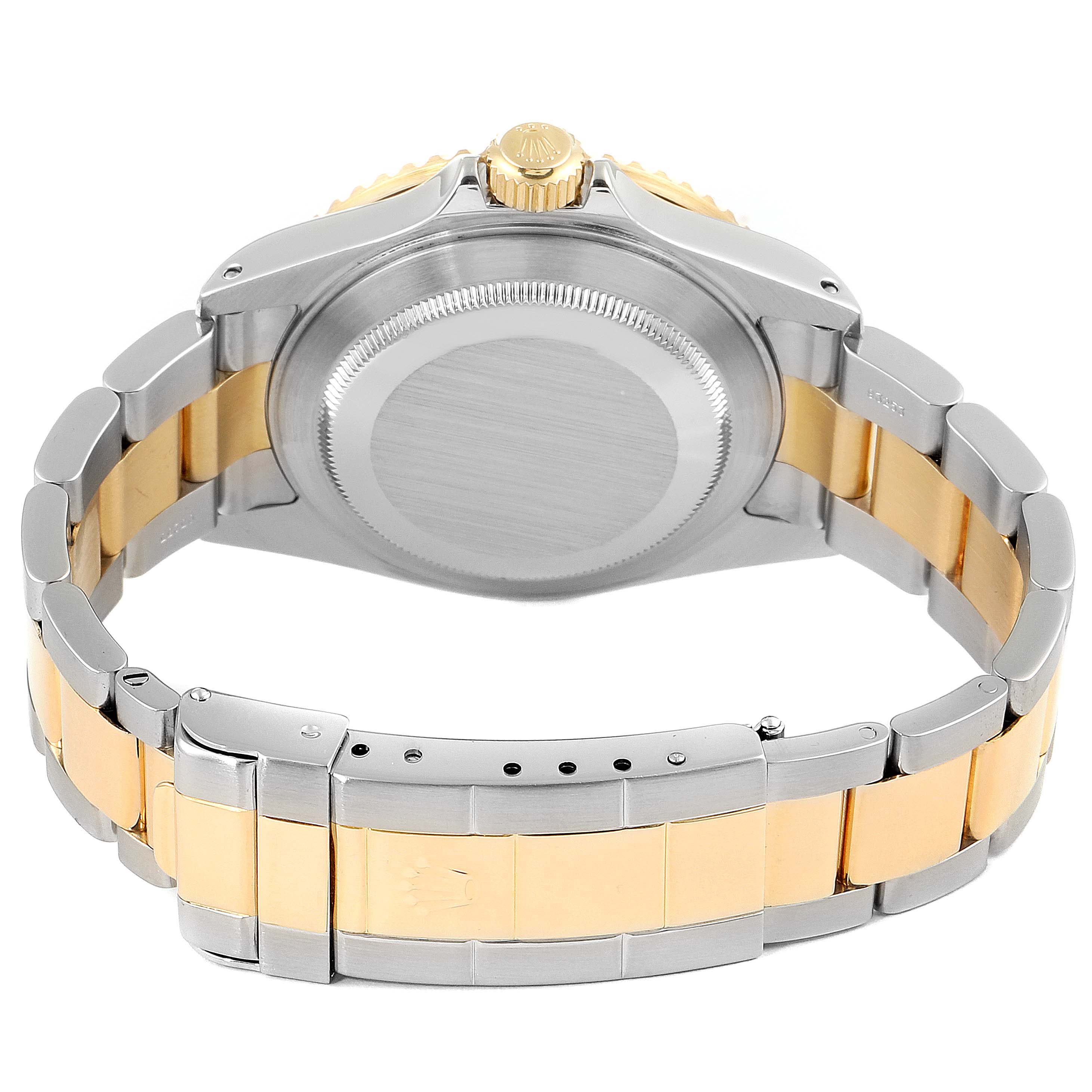 The image shows the back view of a Rolex Submariner 16613 Men's Steel and Gold (two tone) Black Dial 16613 Men's Steel and Gold (two tone) Black Dial watch, highlighting its case back, crown, and two-tone bracelet.