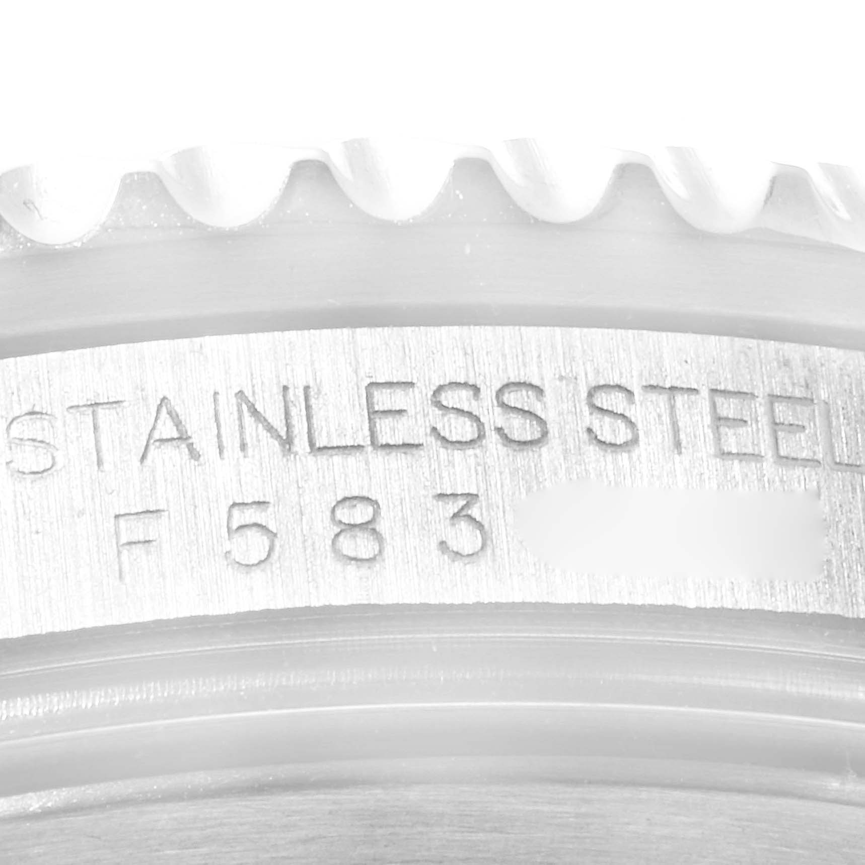 The image shows a close-up of the case back of a Rolex Submariner 16610LV Men
s Stainless Steel Black Dial 16610LV Men
s Stainless Steel Black Dial watch with the "STAINLESS STEEL" engraving and partial serial number visible.
