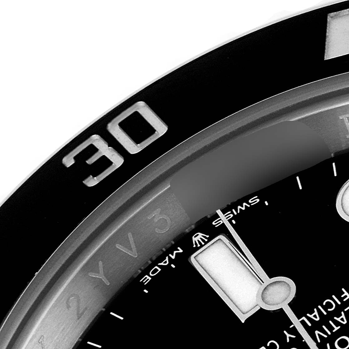 This image shows a close-up of the bezel and part of the dial of a Rolex Submariner 124060 Men
s Stainless Steel Black Dial 124060 Men
s Stainless Steel Black Dial watch, specifically near the 30-minute mark.