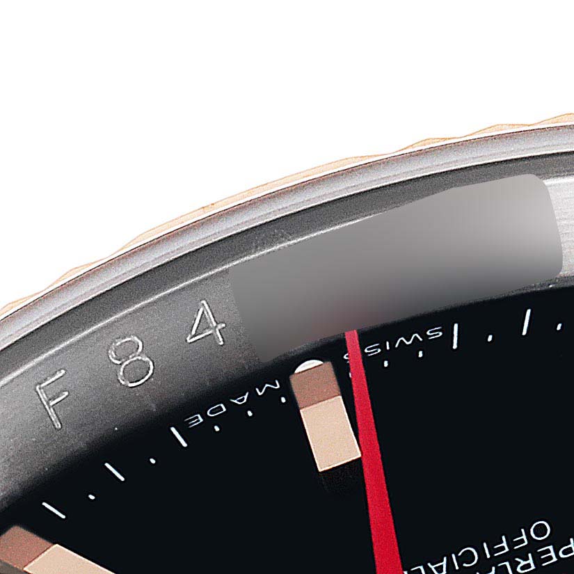 The image shows a close-up of the bezel and a portion of the dial of a Rolex Turn-o-Graph 116261 Men
s Steel and Gold (two tone) Black Dial 116261 Men
s Steel and Gold (two tone) Black Dial watch.