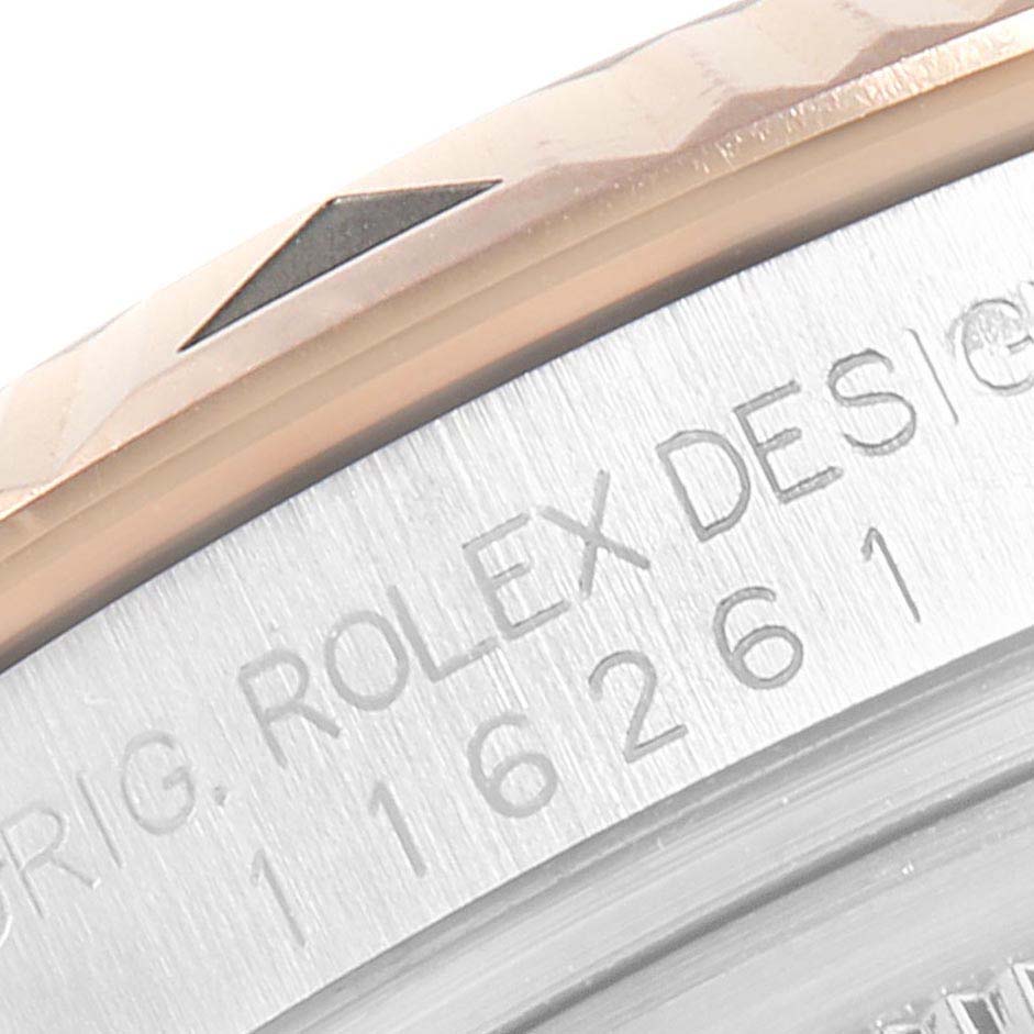 The image shows a close-up of the Rolex Turn-o-Graph 116261 Men
s Steel and Gold (two tone) Black Dial 116261 Men
s Steel and Gold (two tone) Black Dial model
s bezel and engraved case back.