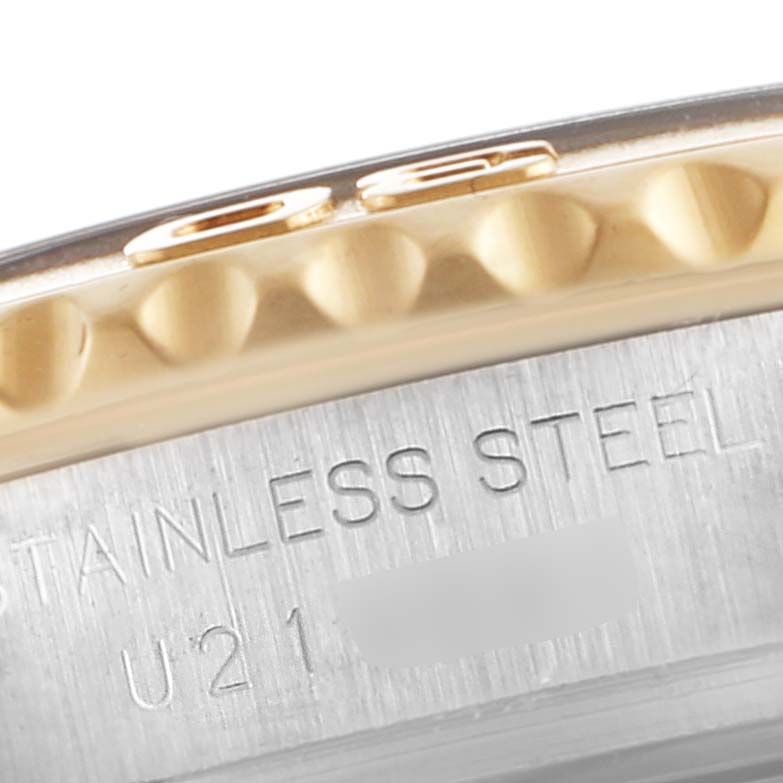 This image shows a close-up of the side of the bezel and case back for the Rolex Yacht-Master 69623 Women's Steel and Gold (two tone) White Dial 69623 Women's Steel and Gold (two tone) White Dial watch, highlighting the "STAINLESS STEEL" engraving.