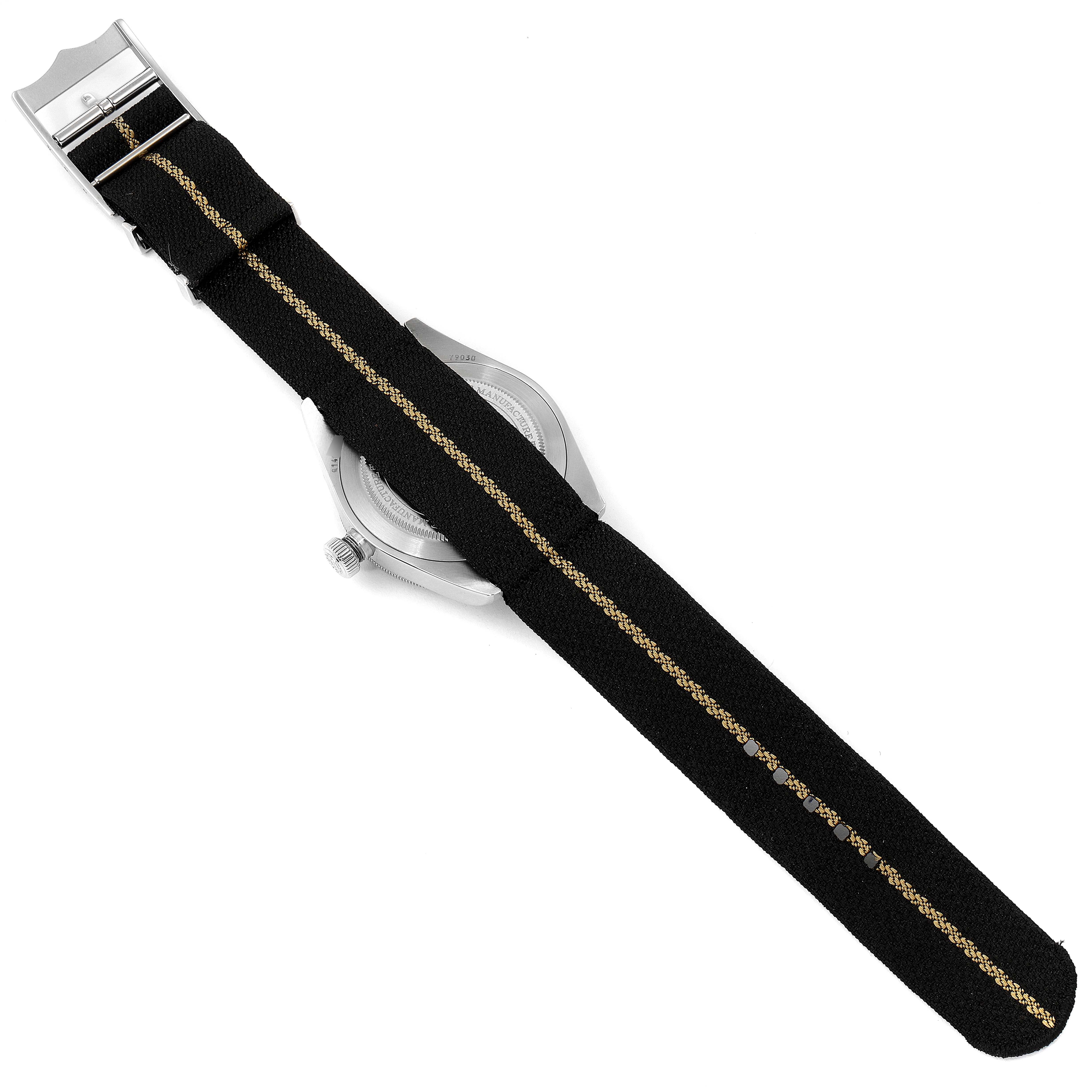 The image shows the back and side view of the Tudor Heritage Black Bay 79030N Men
s Stainless Steel Black Dial 79030N Men
s Stainless Steel Black Dial watch, focusing on its black fabric strap with a central beige stripe.