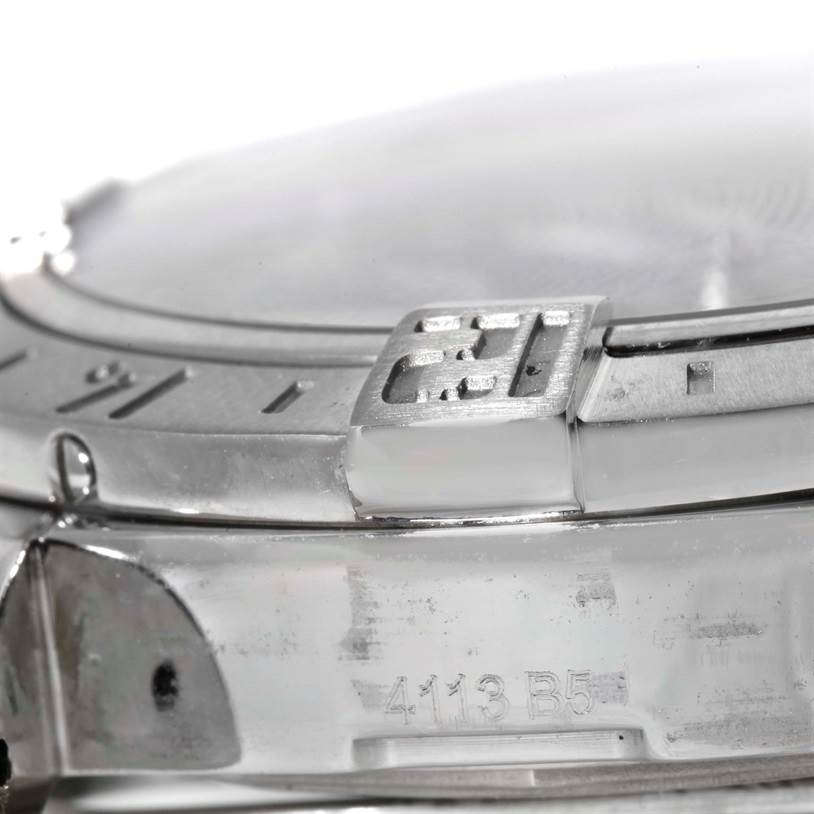 This close-up angle of the Breitling Avenger A32390 Men's Stainless Steel Blue Dial A32390 Men's Stainless Steel Blue Dial watch shows part of the bezel and case, including a visible serial number.