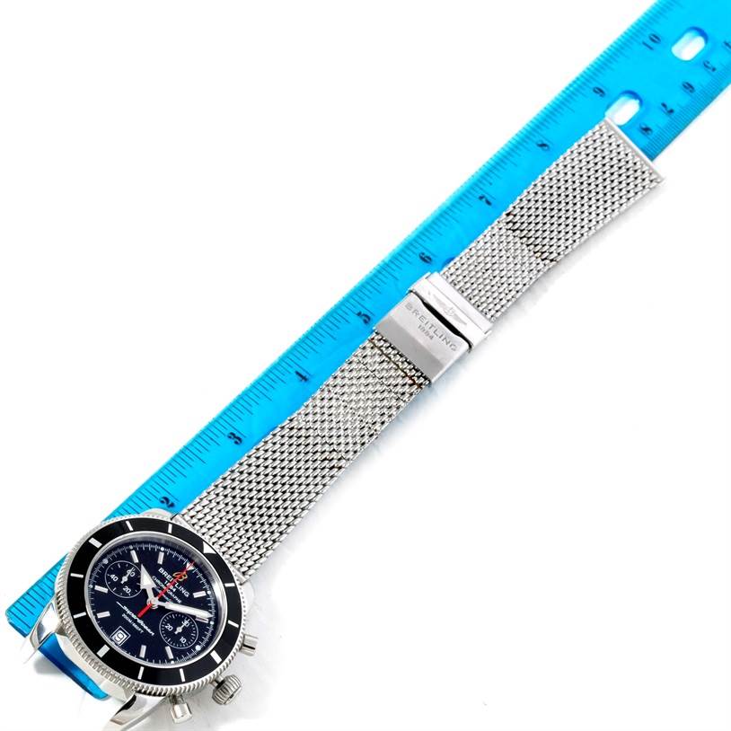 The Breitling Superocean A23370 Men's Stainless Steel Black Dial A23370 Men's Stainless Steel Black Dial watch is shown from a top-down angle, highlighting its face, mesh strap, and clasp.