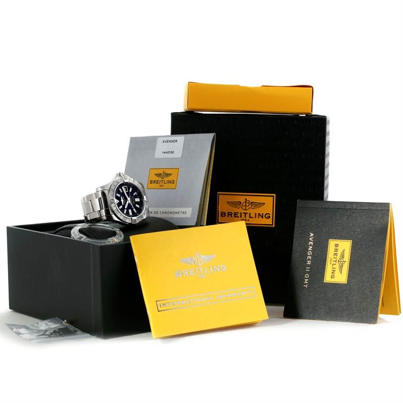 The image shows a Breitling Avenger A32390 Men's Stainless Steel Black Dial A32390 Men's Stainless Steel Black Dial watch and its accessories, including manuals and original packaging.