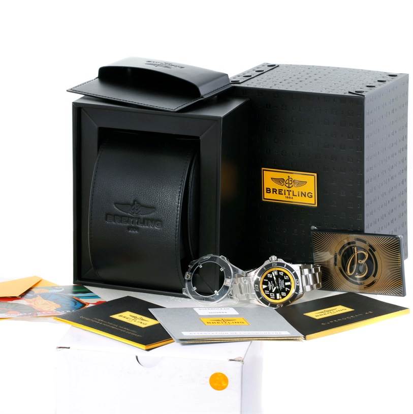 The image shows the Breitling Superocean A17364 Men's Stainless Steel Black Dial A17364 Men's Stainless Steel Black Dial watch, a black display box, packaging, manuals, and an additional bezel from a frontal angle.