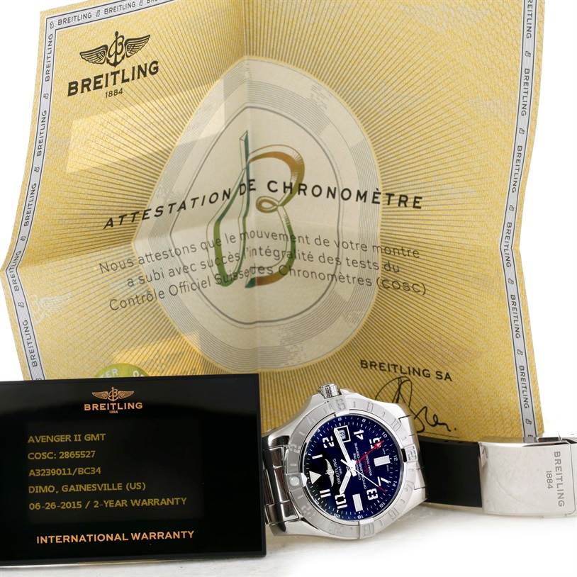 The image shows a Breitling Avenger A32390 Men's Stainless Steel Black Dial A32390 Men's Stainless Steel Black Dial II GMT watch with its warranty card and chronometer certificate, displaying the watch face and bracelet.