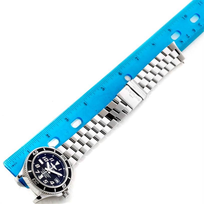 The image shows a Breitling Superocean A17364 Men's Stainless Steel Black Dial A17364 Men's Stainless Steel Black Dial watch lying flat with the dial, bezel, and full metal bracelet visible next to a ruler.