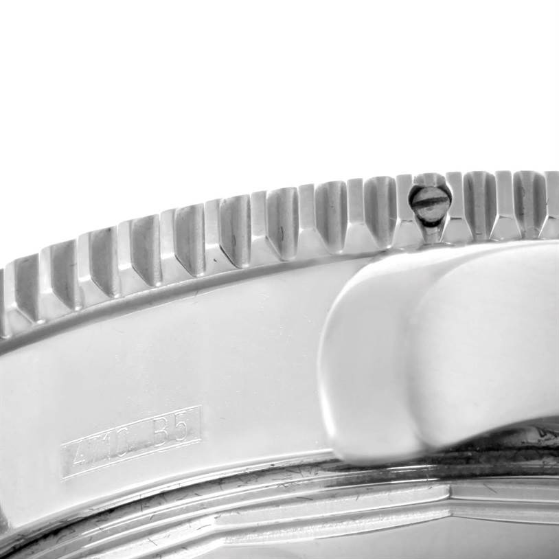 The image shows a close-up of the bezel and part of the case of a Breitling Superocean A17364 Men's Stainless Steel Black Dial A17364 Men's Stainless Steel Black Dial watch.