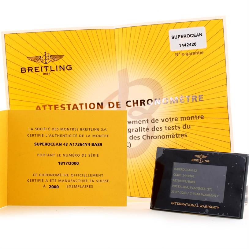 The image shows documents including a certificate of authentication and international warranty card for the Breitling Superocean A17364 Men's Stainless Steel Black Dial A17364 Men's Stainless Steel Black Dial model.