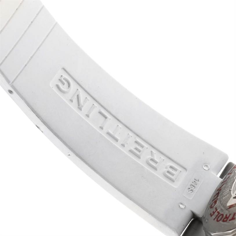 The image shows a close-up of the white rubber strap with the Breitling logo from the Superocean model watch.