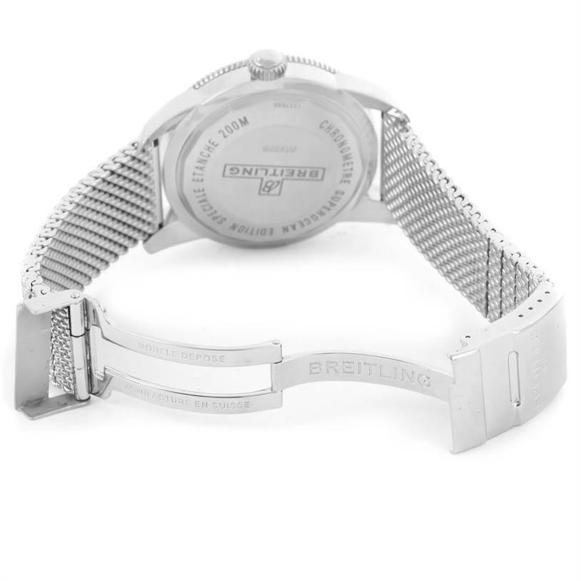 The image shows the back of a Breitling Superocean A17320 Men's Stainless Steel Blue Dial A17320 Men's Stainless Steel Blue Dial watch and its open metal mesh bracelet clasp.