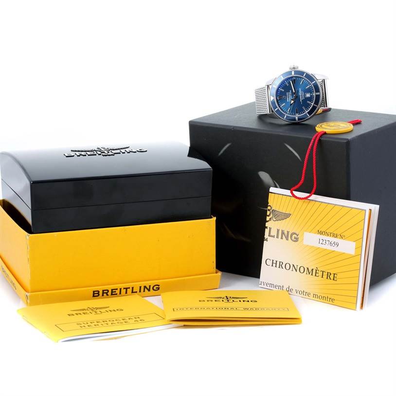 The image shows a Breitling Superocean A17320 Men's Stainless Steel Blue Dial A17320 Men's Stainless Steel Blue Dial watch at an angle, the watch box, manuals, and accompanying documentation.
