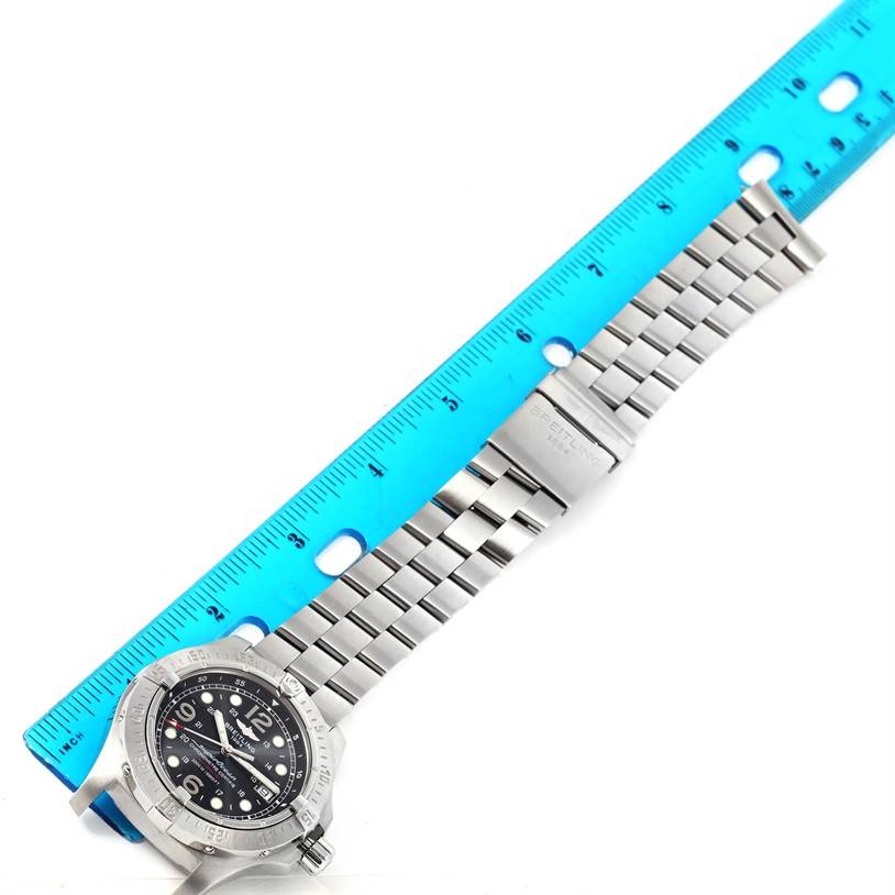 The photo shows a top-down view of the Breitling Superocean A17390 Men's Stainless Steel Black Dial A17390 Men's Stainless Steel Black Dial watch along with a blue ruler for scale.