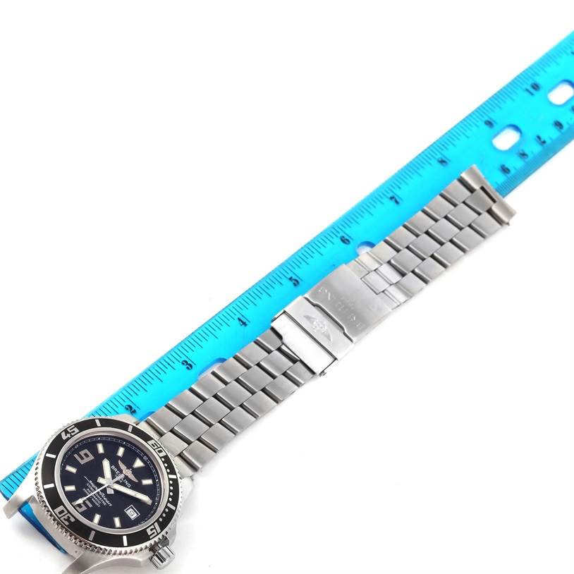 The image shows a Breitling Superocean A17391 Men's Stainless Steel Black Dial A17391 Men's Stainless Steel Black Dial watch laid out flat with a metal strap and a blue ruler for scale.