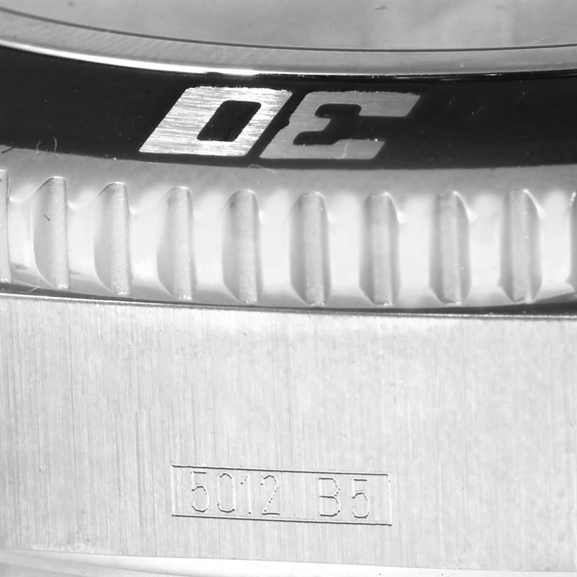 This close-up image of a Breitling Superocean A17391 Men's Stainless Steel Black Dial A17391 Men's Stainless Steel Black Dial watch shows the bezel with part of its engraved numerals and the case with engraved markings.