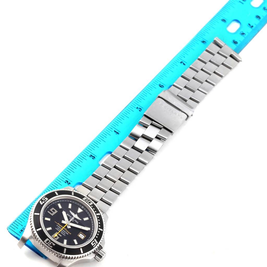 The Breitling Superocean A17391 Men's Stainless Steel Black Dial A17391 Men's Stainless Steel Black Dial watch is shown from an angle displaying the face and metal bracelet with a ruler for scale.