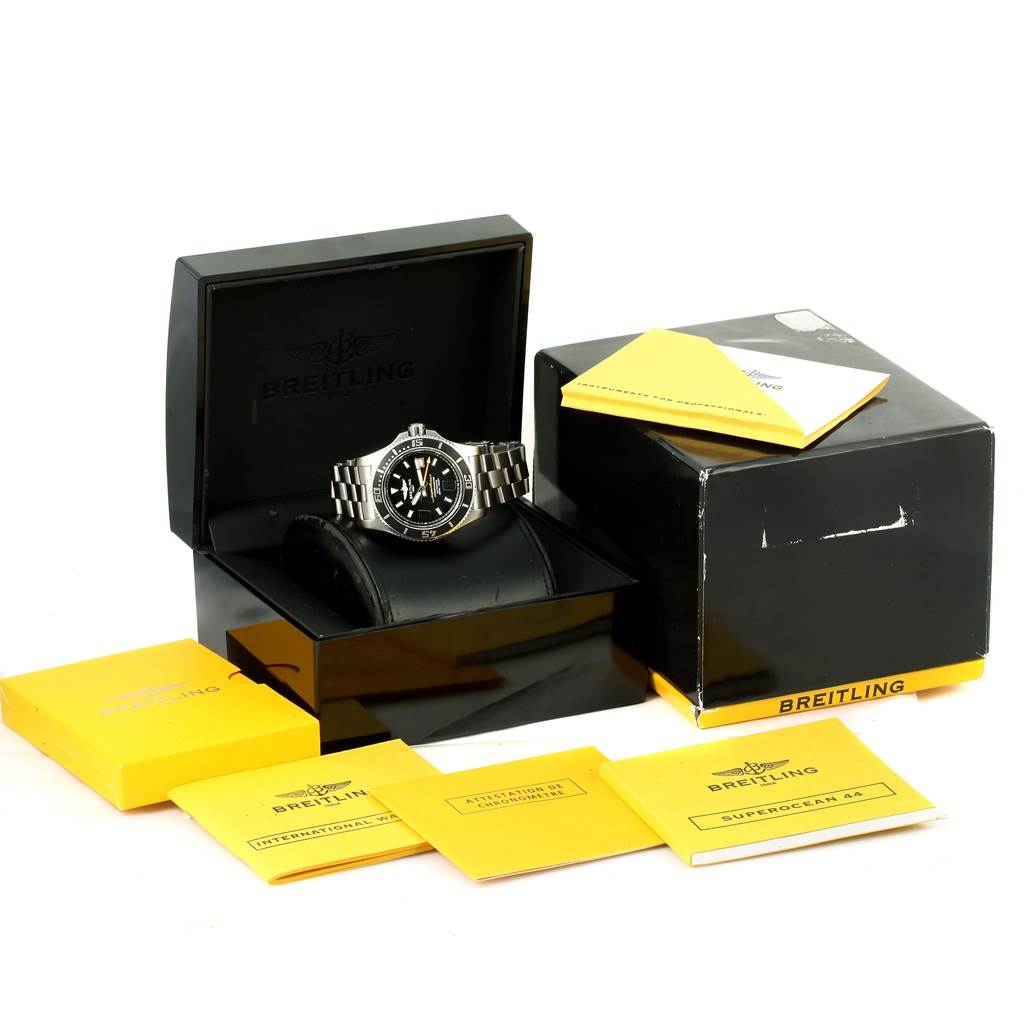 The Breitling Superocean A17391 Men's Stainless Steel Black Dial A17391 Men's Stainless Steel Black Dial watch is shown front-facing in its case, accompanied by its box and several yellow instruction booklets.