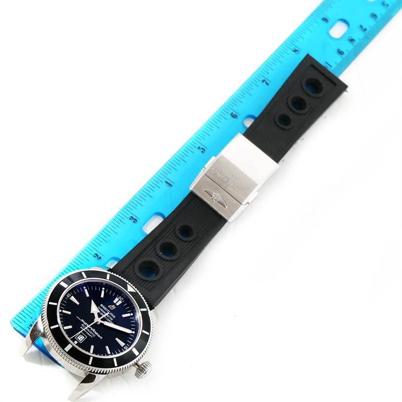The image shows a Breitling Superocean A17320 Men's Stainless Steel Black Dial A17320 Men's Stainless Steel Black Dial watch lying flat, featuring its face, bezel, and rubber strap with a clasp, next to a ruler.
