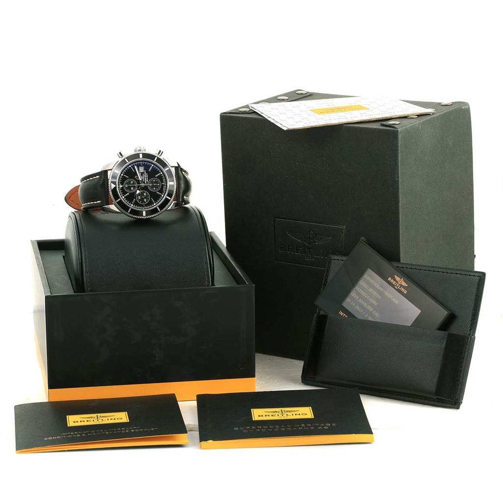 The image shows a Breitling Superocean A13320 Men's Stainless Steel Black Dial A13320 Men's Stainless Steel Black Dial watch with a black leather strap, packaging, manuals, and a warranty card displayed from the front.