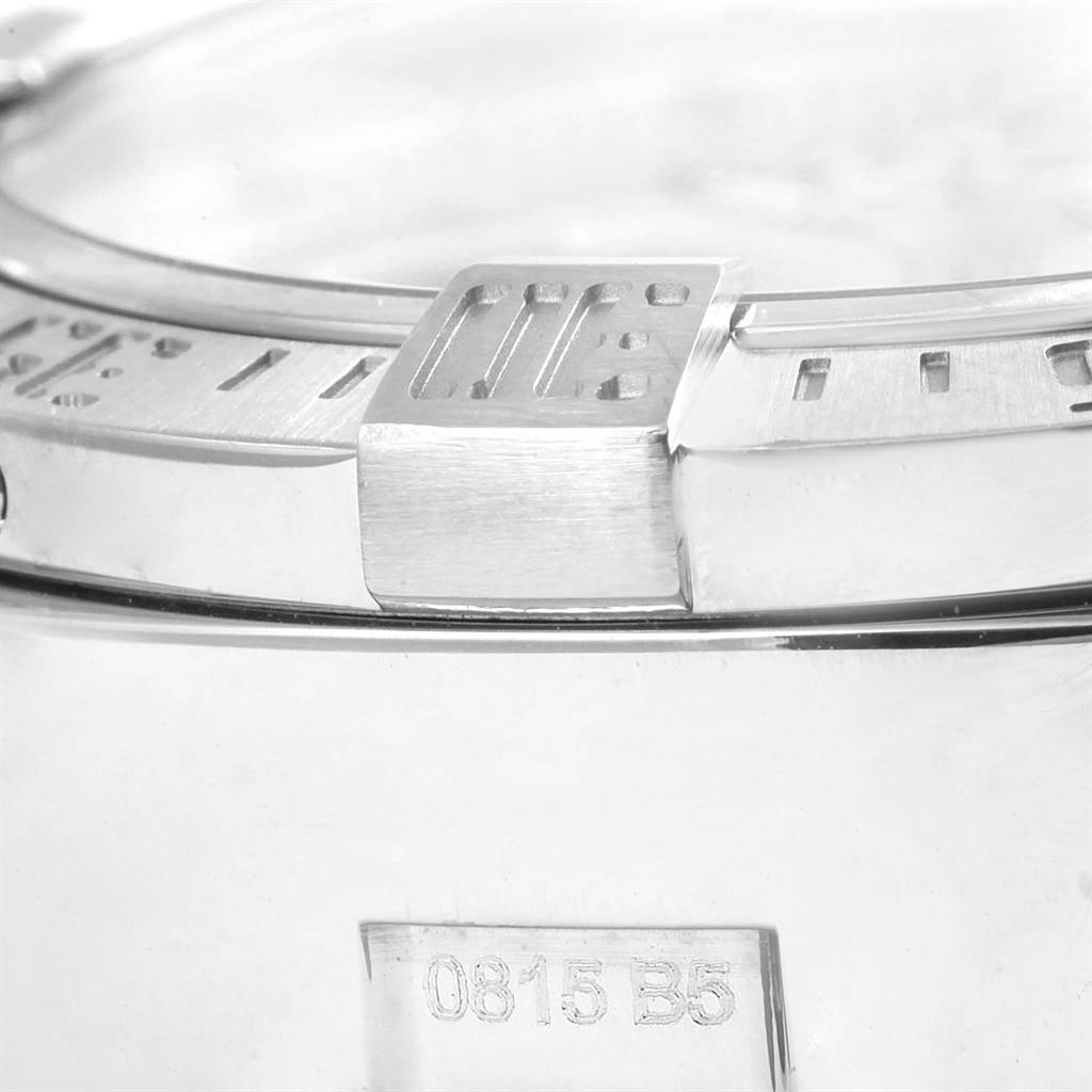 This close-up angle of the Breitling Avenger A13381 Men's Stainless Steel White Dial A13381 Men's Stainless Steel White Dial watch shows the bezel, part of the case, and a screw groove.