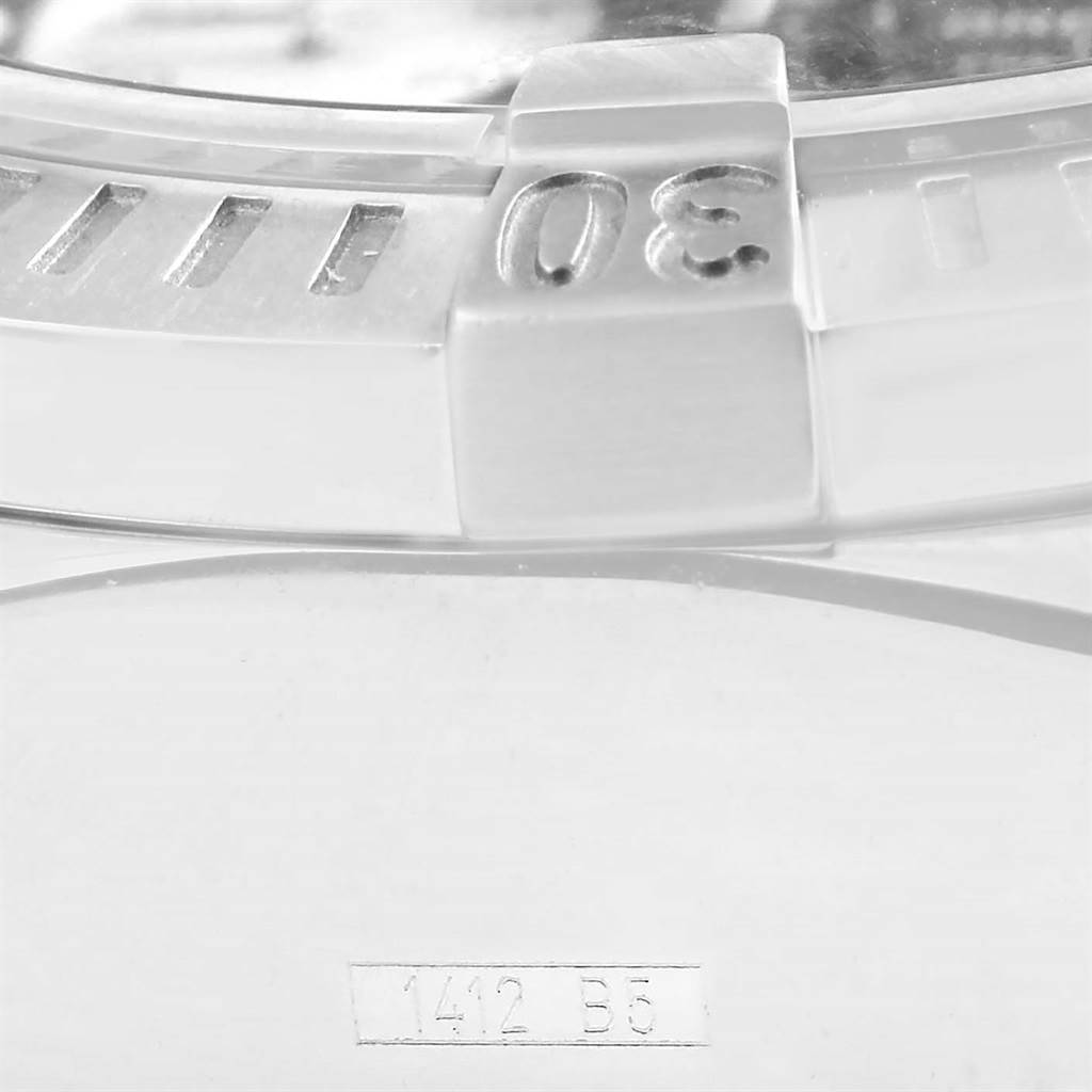 This close-up image shows the bezel of a Breitling Avenger A13370 Men's Stainless Steel Black Dial A13370 Men's Stainless Steel Black Dial watch, focusing on the 30-minute marker and part of the serial number.