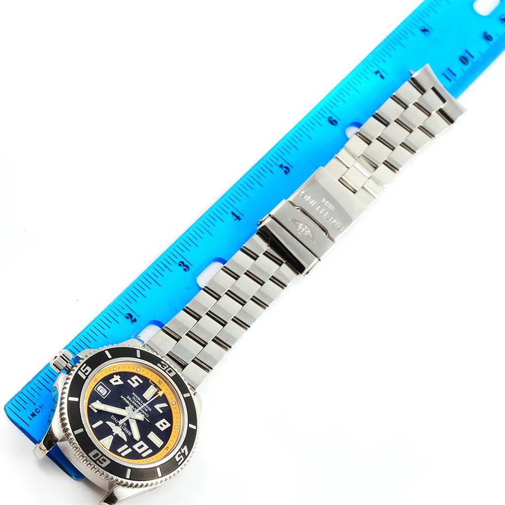 The Breitling Superocean A17364 Men's Stainless Steel Black Dial A17364 Men's Stainless Steel Black Dial watch is displayed flat with a metal bracelet, dial, and bezel visible, alongside a blue ruler for scale.