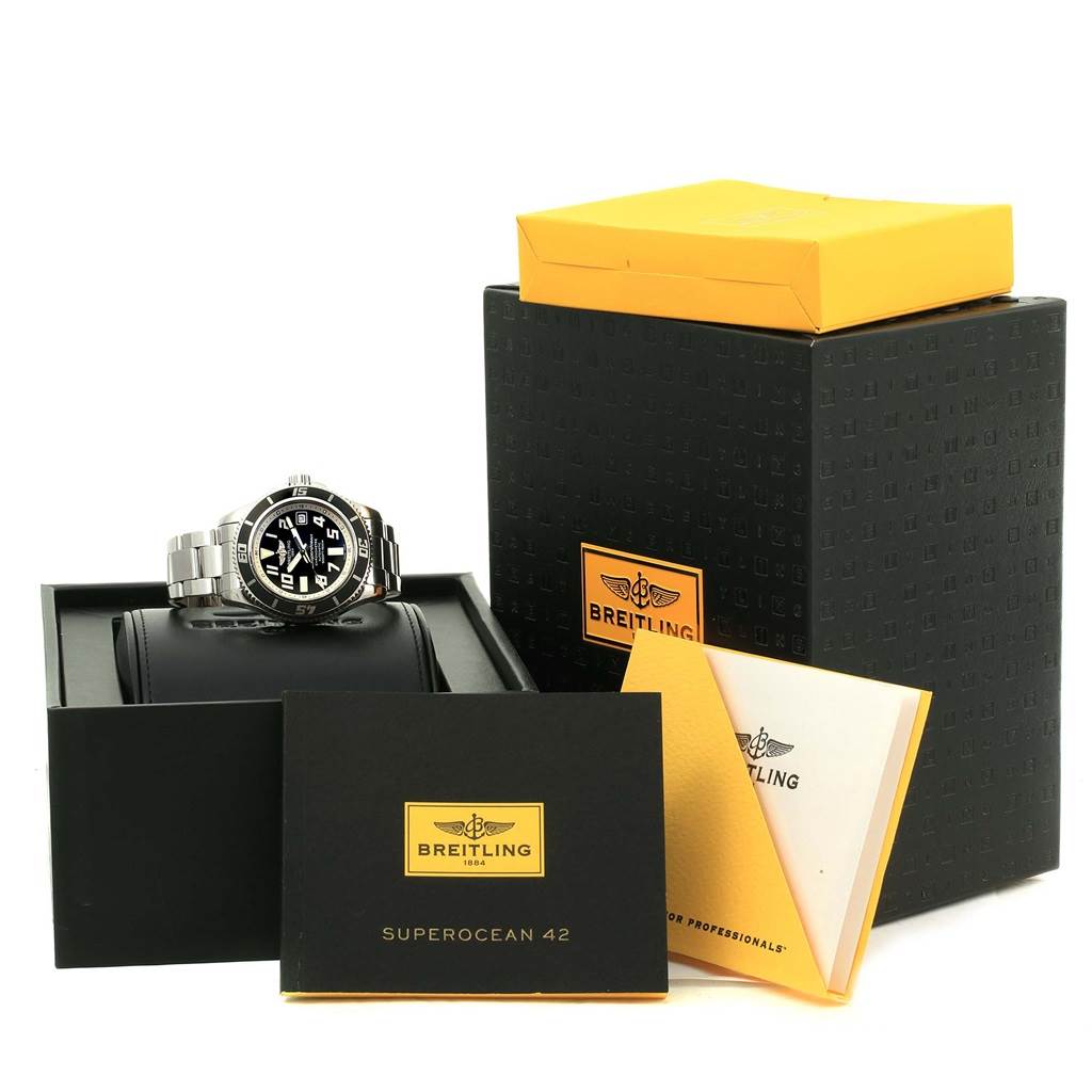 The image shows a Breitling Superocean A17364 Men's Stainless Steel Black Dial A17364 Men's Stainless Steel Black Dial watch at an angle with its box, instruction manual, and warranty card.