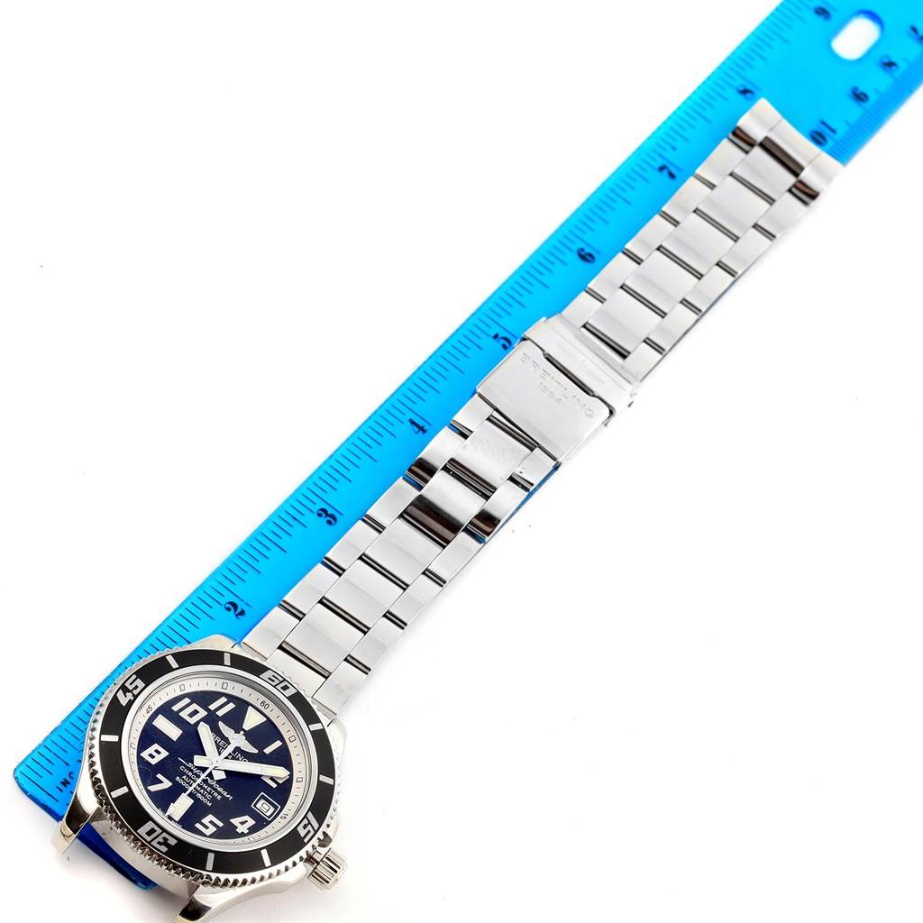The image shows a Breitling Superocean A17364 Men's Stainless Steel Black Dial A17364 Men's Stainless Steel Black Dial watch laid flat next to a ruler, displaying its face and metal bracelet.