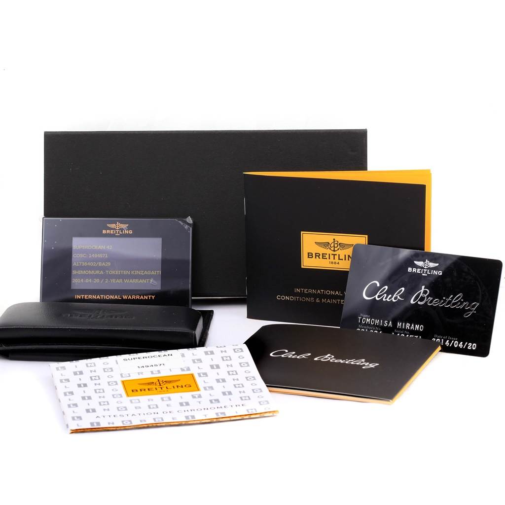 The image shows accessories for the Breitling Superocean A17364 Men's Stainless Steel Black Dial A17364 Men's Stainless Steel Black Dial watch, including warranty cards, manuals, and a case, arranged at an angle.