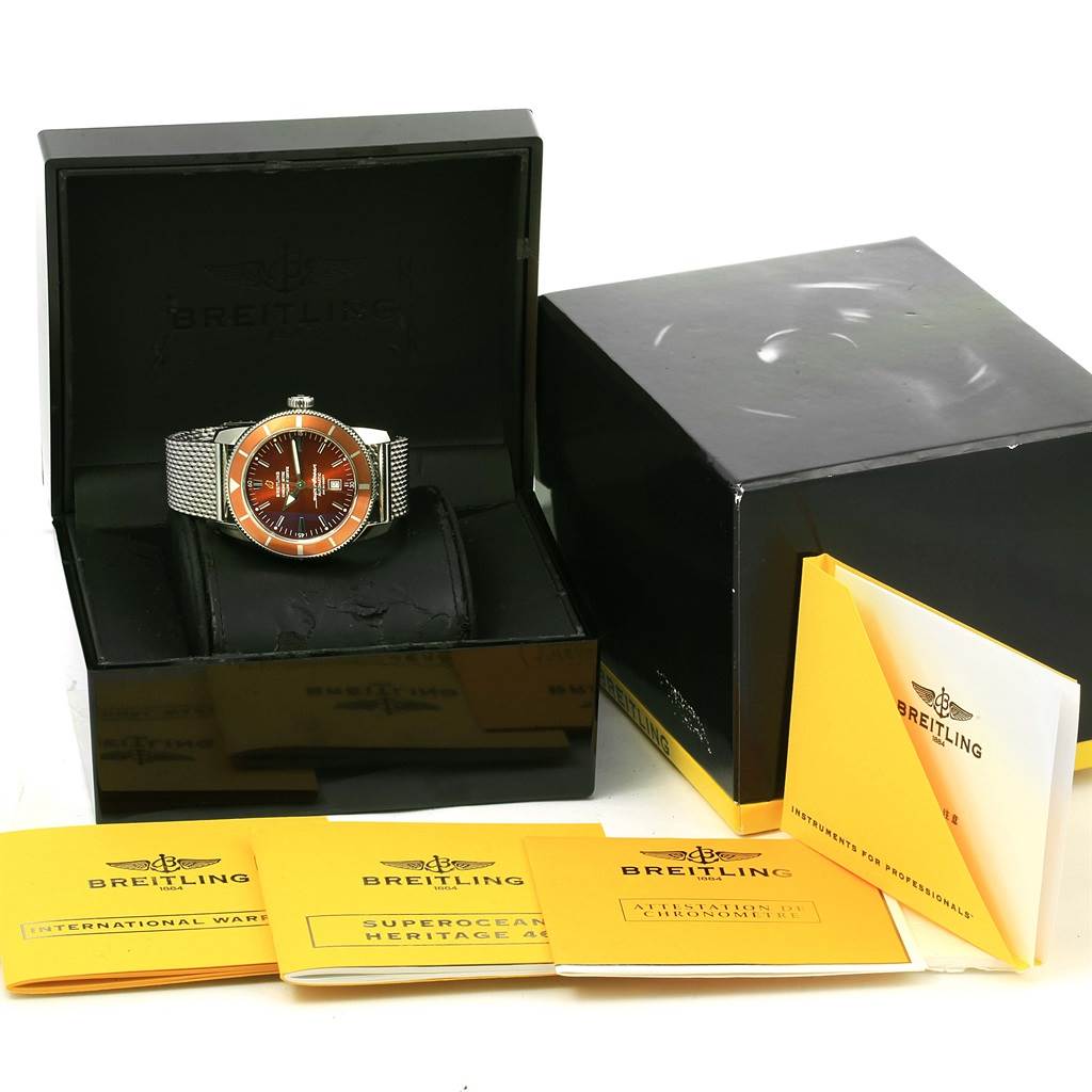 The image shows a Breitling Superocean A17320 Men's Stainless Steel Brown Dial A17320 Men's Stainless Steel Brown Dial watch in its open box with accompanying booklets and warranty cards displayed in the foreground.